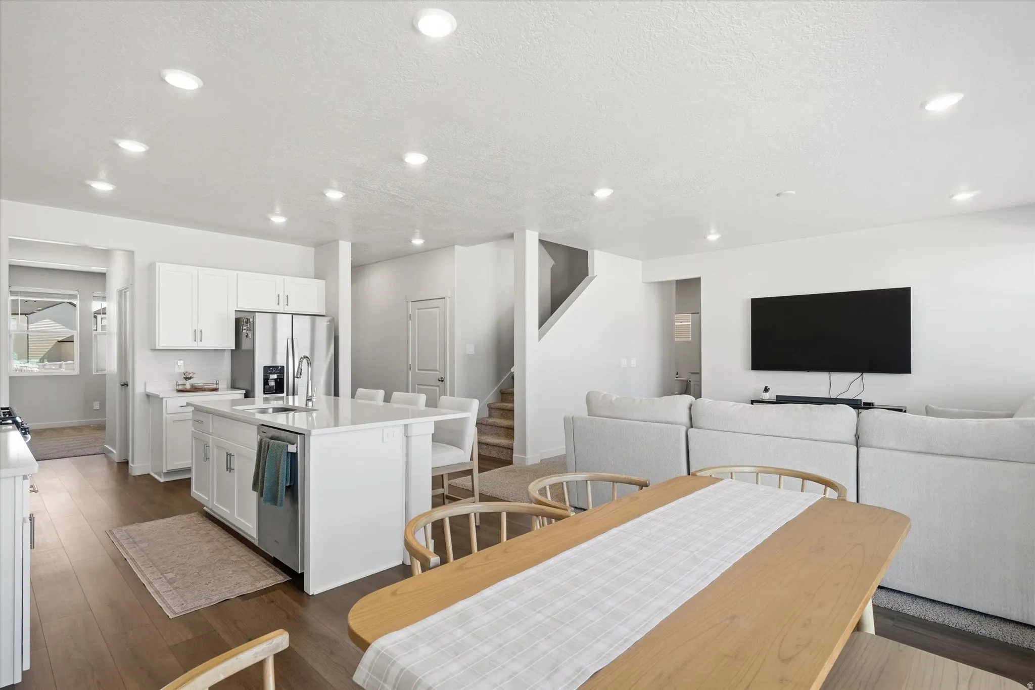 Open-concept living area with wood-finish flooring