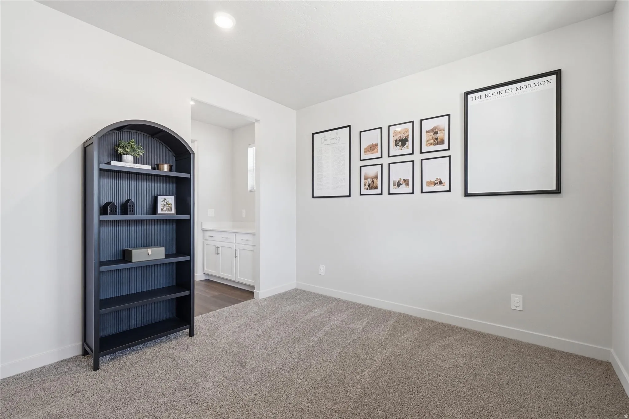 Grey carpeting paired with light neutral wall tones, featuring a built-in recessed ceiling light