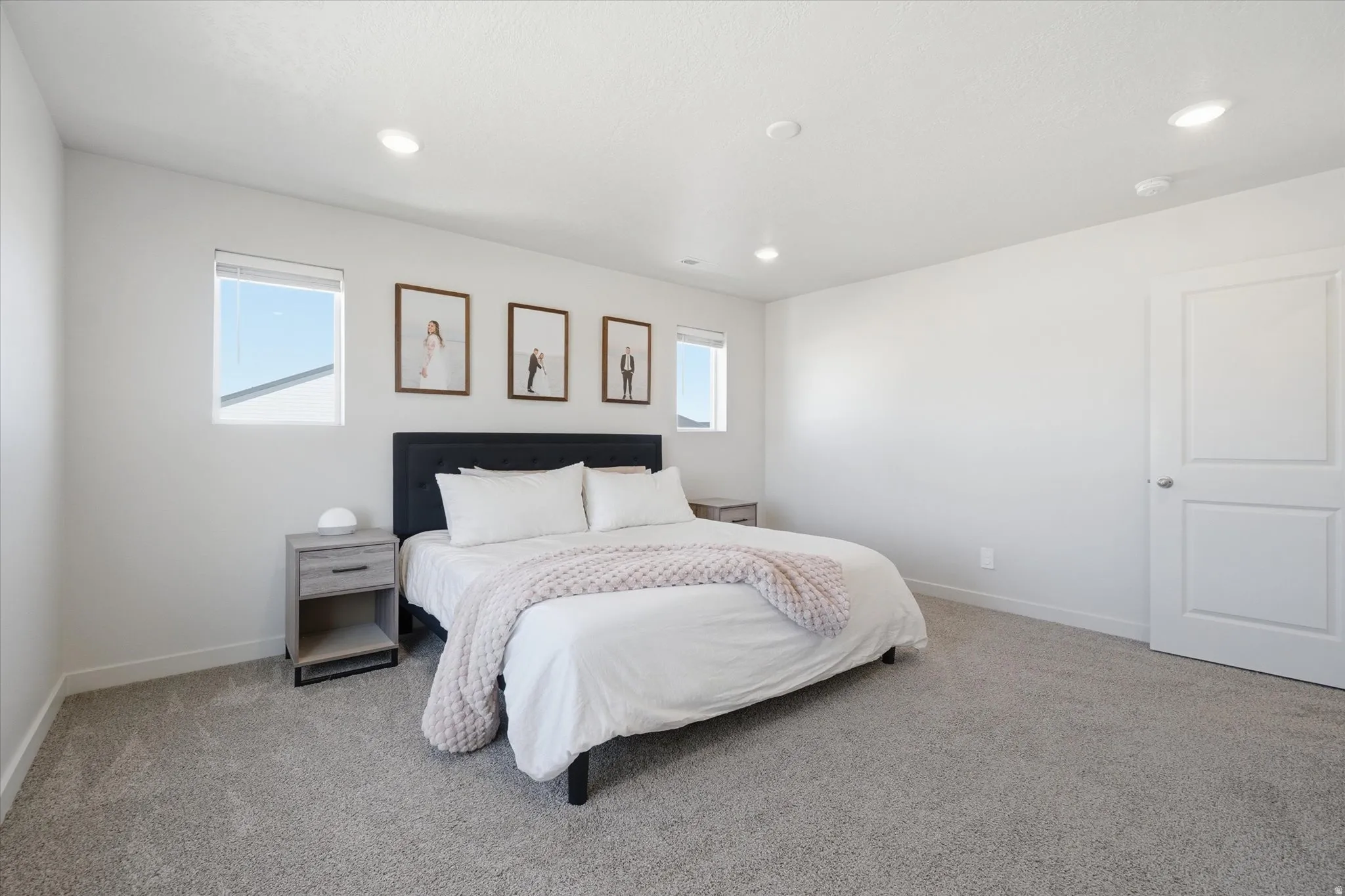 Spacious room with light gray carpeting and white walls