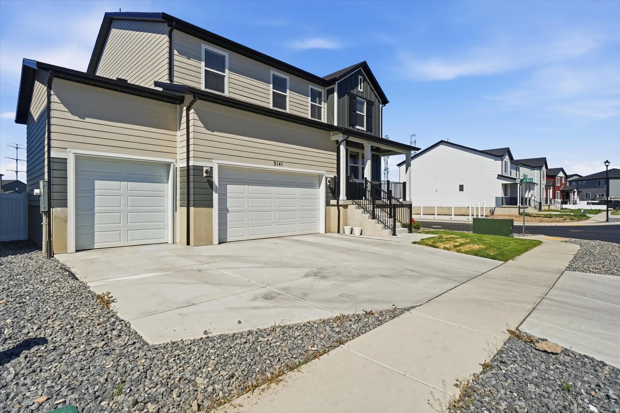 Contemporary two-story residence featuring a dual-tone siding exterior and a prominent two-car garage