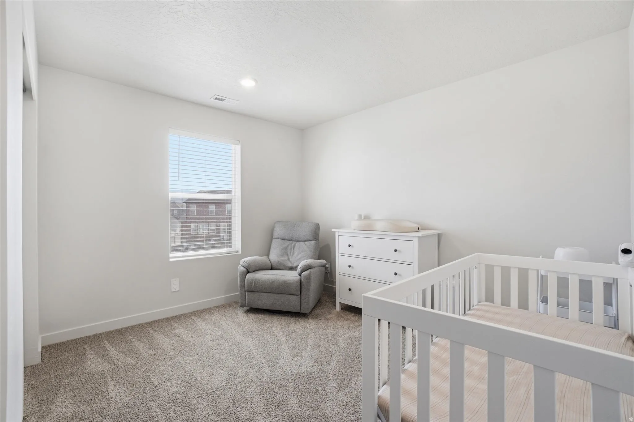Neutral gray carpeting complements the bright white walls and trim