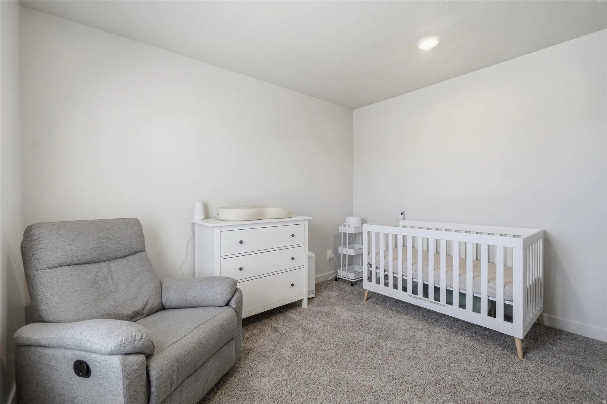 Carpeted room featuring light-toned wall paint and a recessed ceiling light