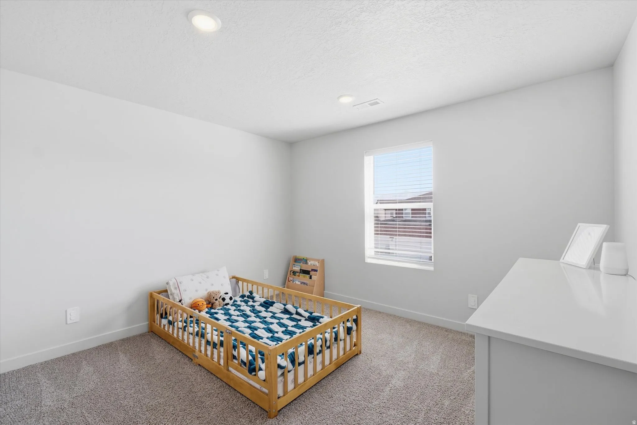 Neutral-toned walls complement plush carpeting