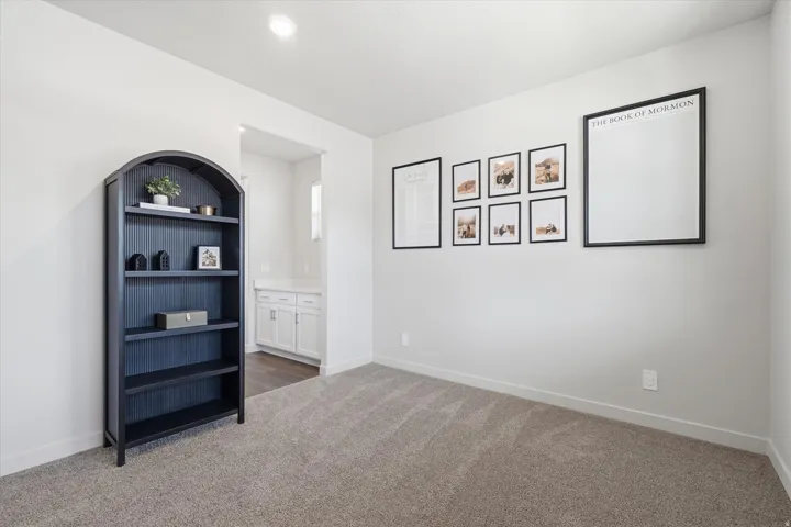 Grey carpeting paired with light neutral wall tones, featuring a built-in recessed ceiling light