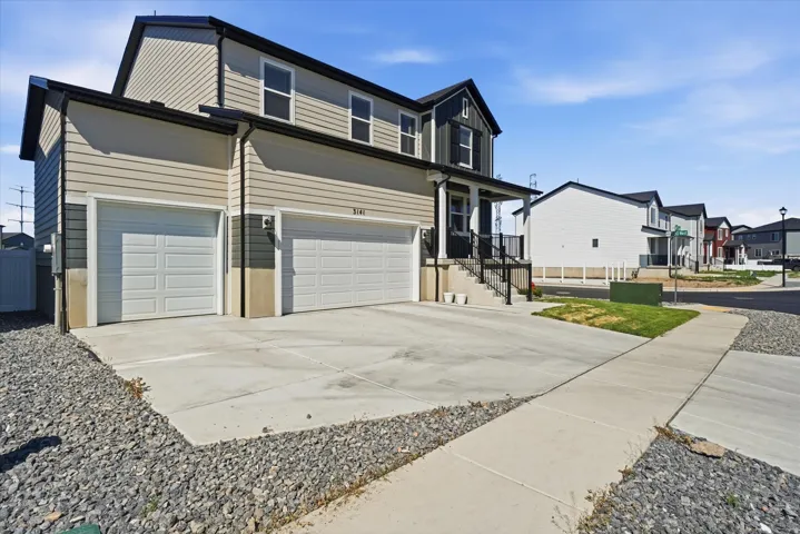 Contemporary two-story residence featuring a dual-tone siding exterior and a prominent two-car garage