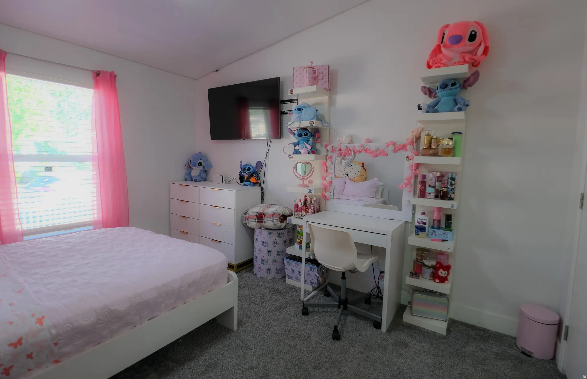Room featuring light gray carpet flooring, white walls, a window with horizontal blinds, and a built-in wall-mounted television