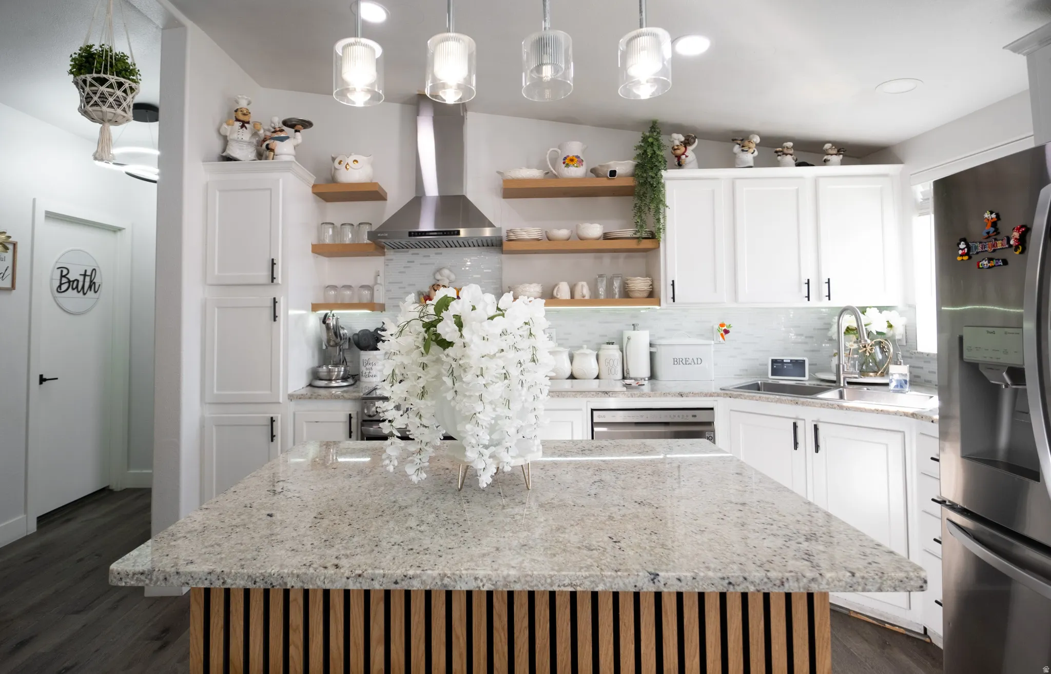 Kitchen island featuring a granite countertop and a slatted wood-finish base