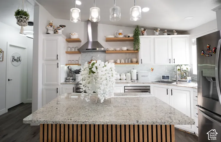 Kitchen island featuring a granite countertop and a slatted wood-finish base