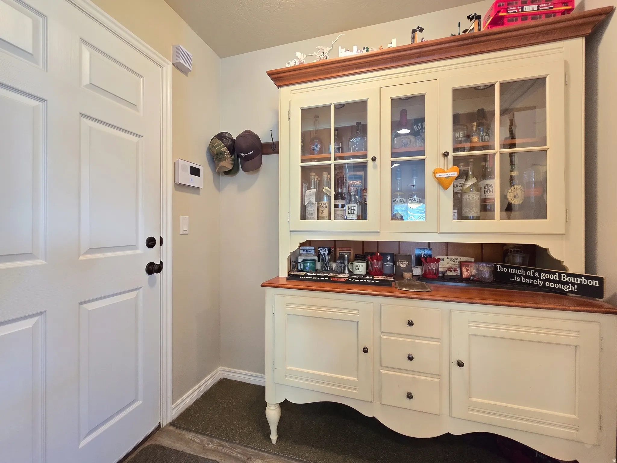 Entryway with a paneled white door, dark bronze hardware, and light neutral wall paint
