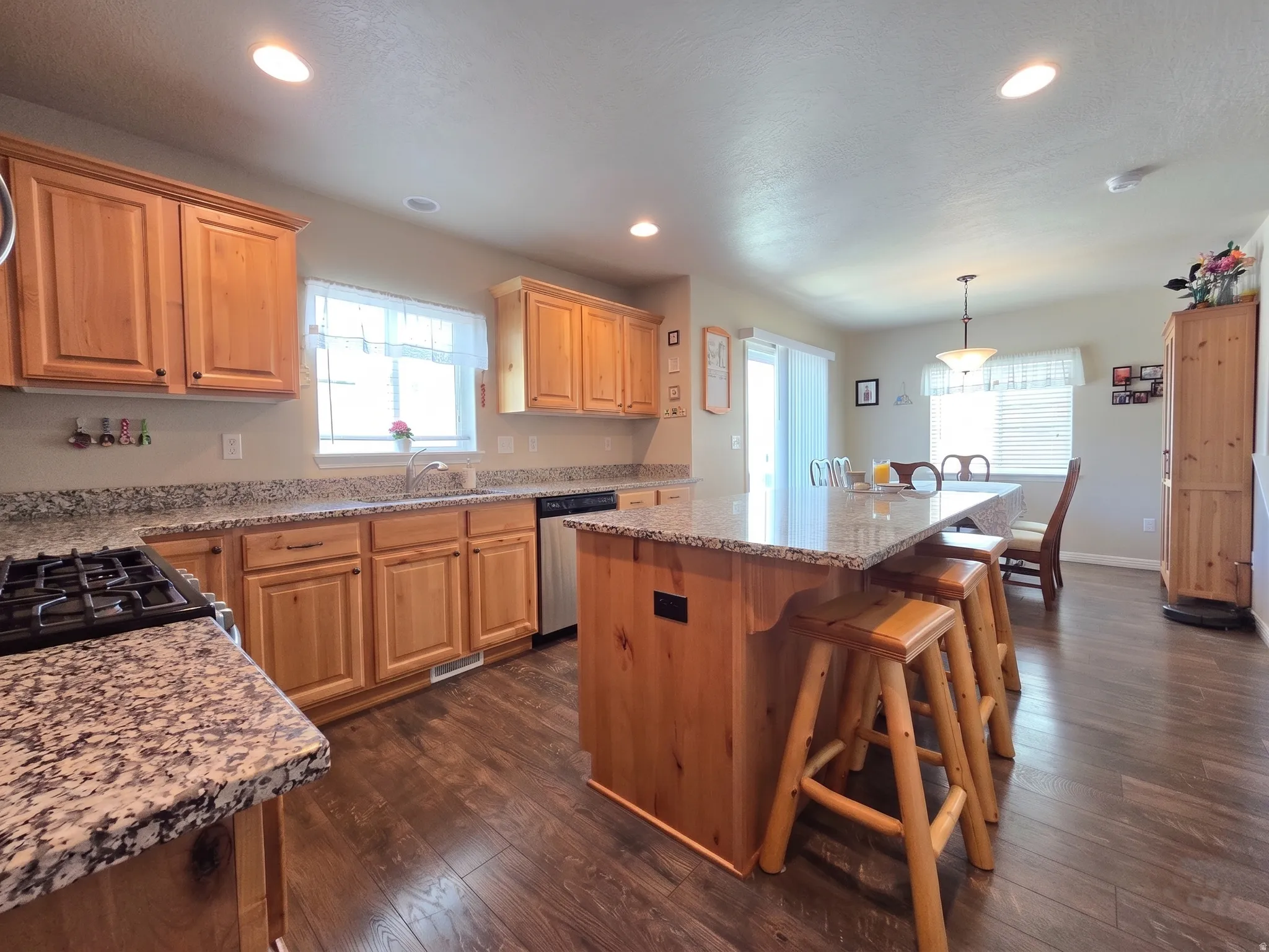 Kitchen featuring light wood cabinetry and speckled countertops