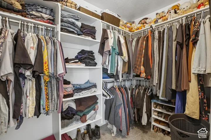 Custom closet system featuring multiple hanging rods, integrated shelving, and corner storage
