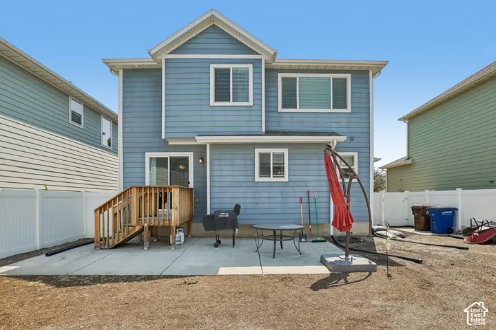 Two-story residence featuring blue siding and white window trim