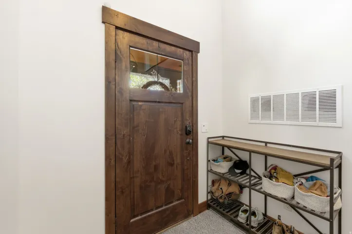 Rich wood-finish entry door with clear glass panel