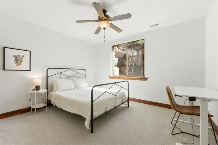 Neutral wall tones complement the light-colored carpet flooring