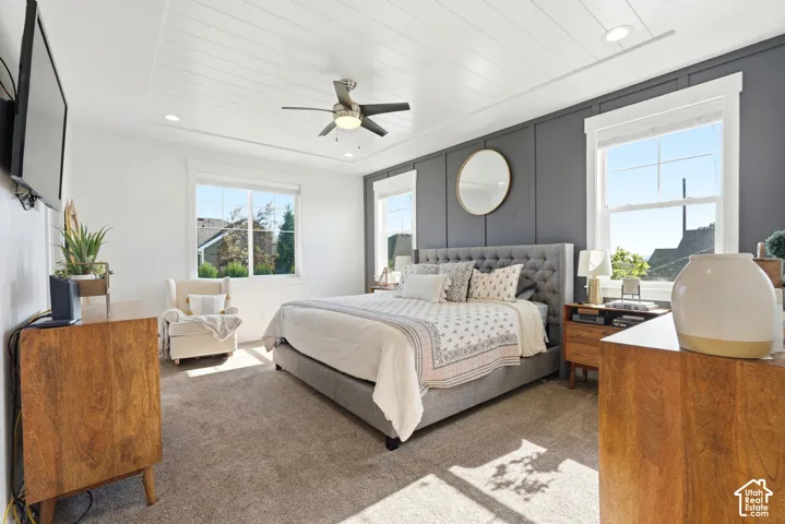 Bedroom featuring textured carpeting, a tray ceiling with shiplap detailing and recessed lighting, and a ceiling fan