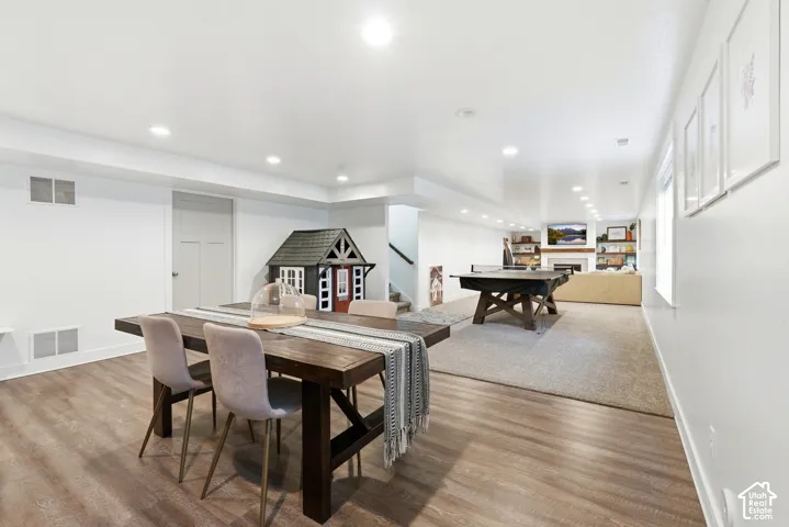 Finished basement featuring wood-finish flooring, recessed lighting, and a neutral color palette