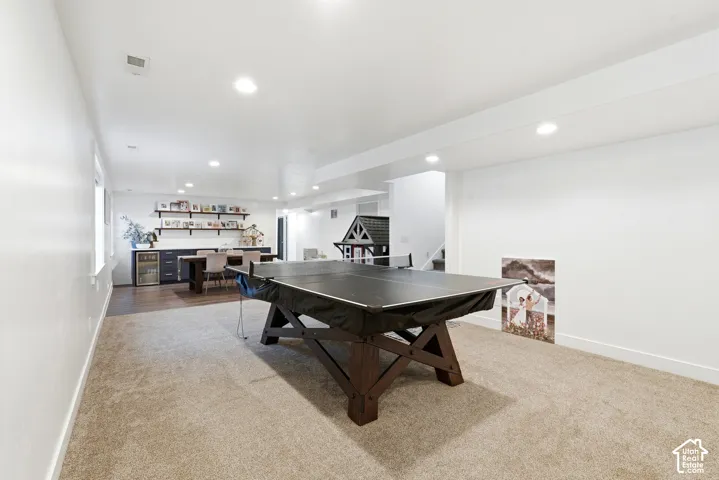 Spacious recreation room featuring plush carpet flooring