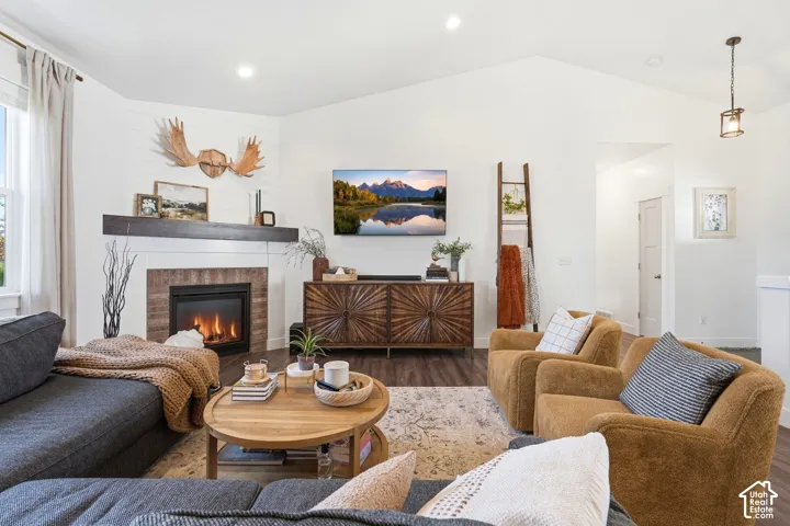 Spacious living area featuring a vaulted ceiling with recessed lighting