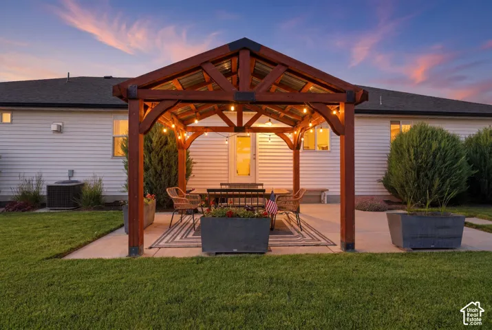 Covered outdoor patio with a wood-frame gazebo and string lighting