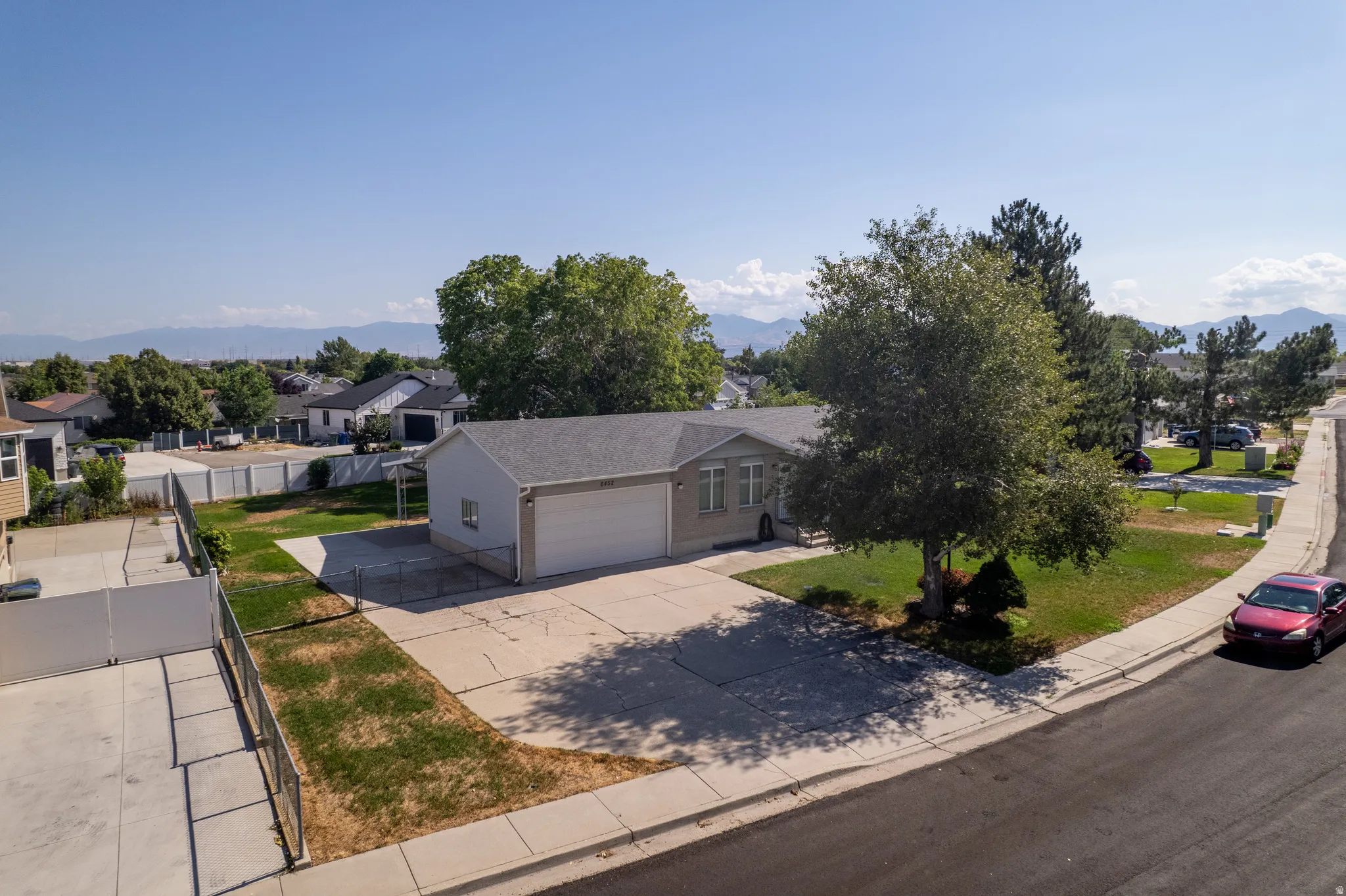Single-story residence featuring a two-car garage and a paved driveway