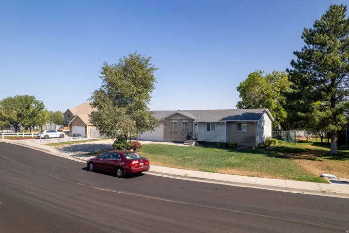 Single-story residence featuring a gray exterior and a shingled roof