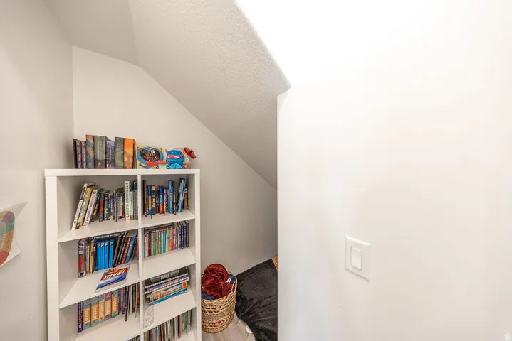Built-in shelving beneath an angled ceiling, providing integrated storage within a compact area