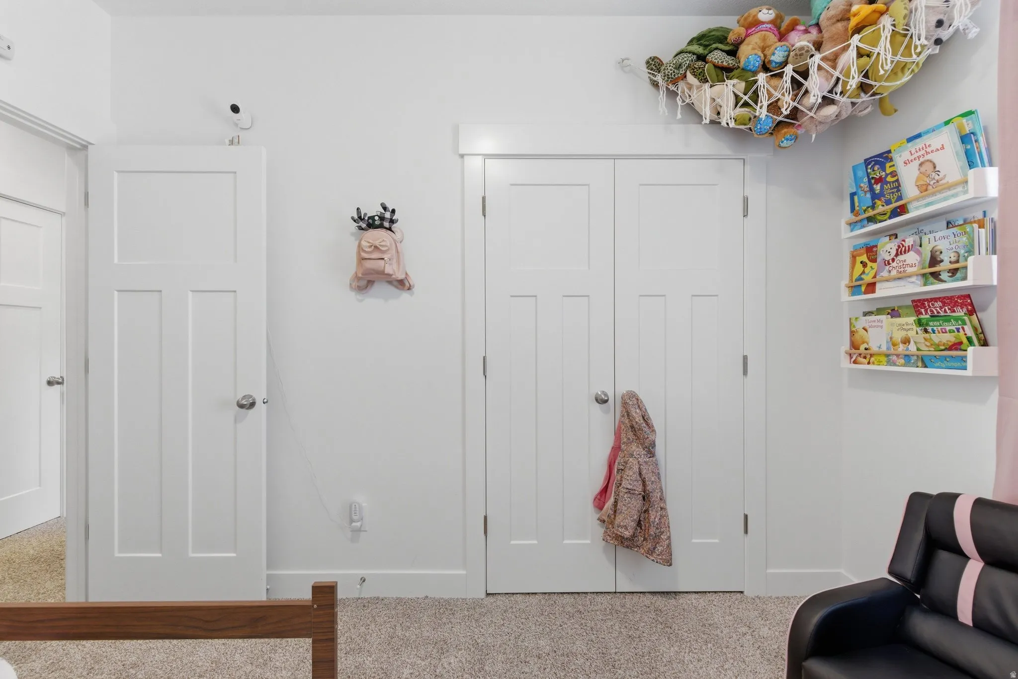 White paneled doors with brushed nickel hardware, light neutral carpet, and white baseboards