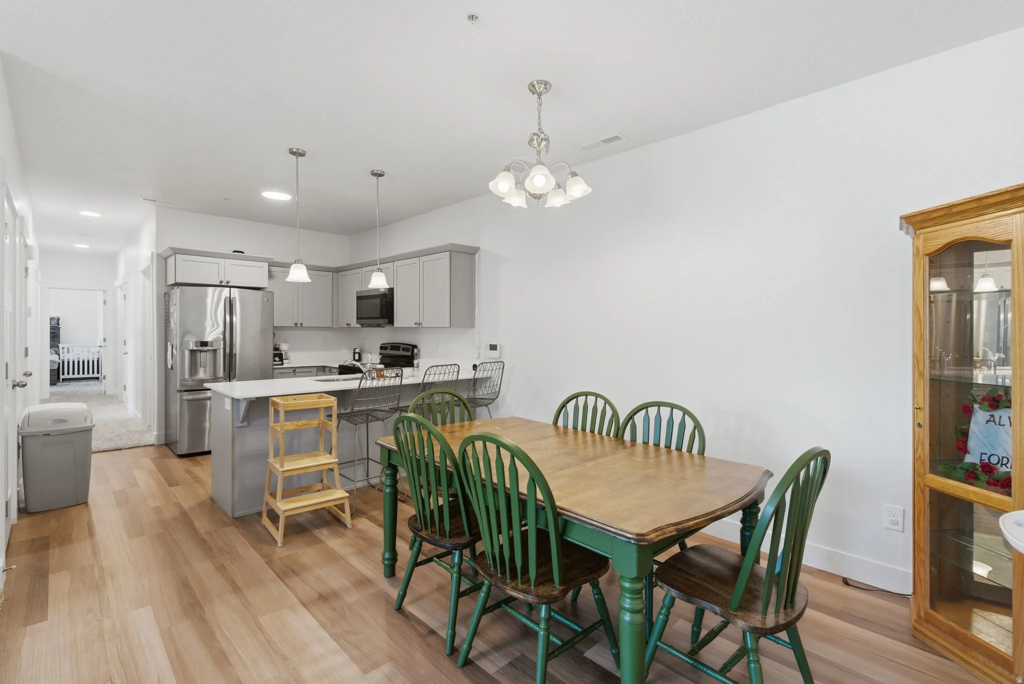Open-concept kitchen and dining area featuring light wood-finish flooring