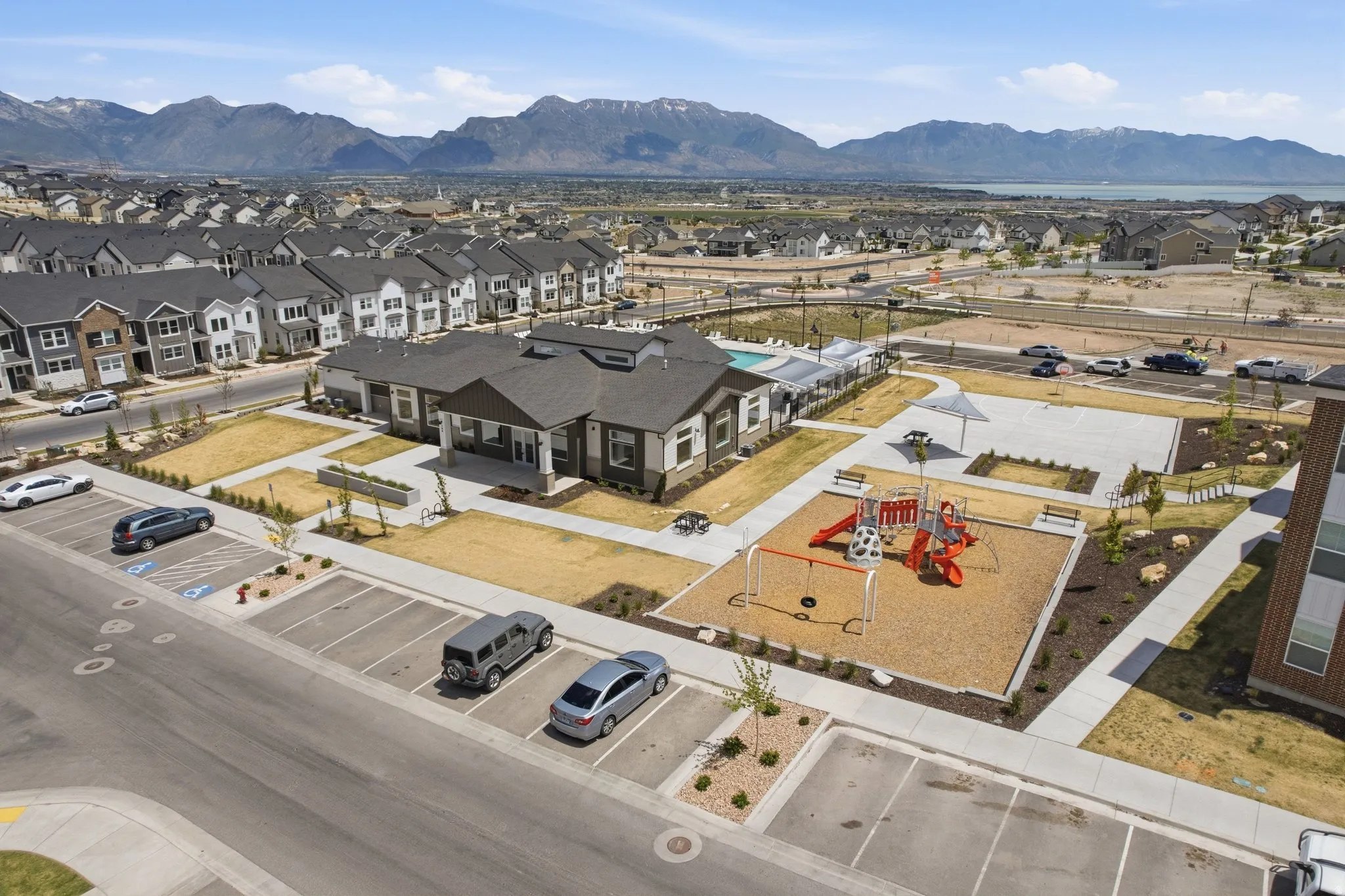 Community amenities including a playground with swings and slides, a swimming pool, and dedicated parking