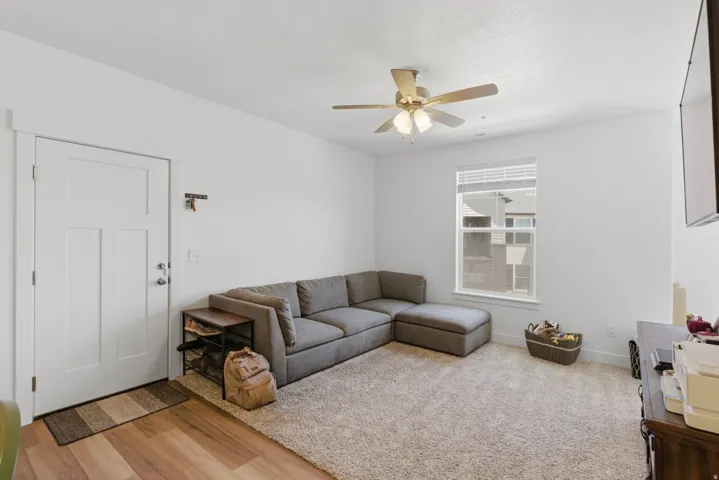 Living area with light-colored walls and carpeted flooring