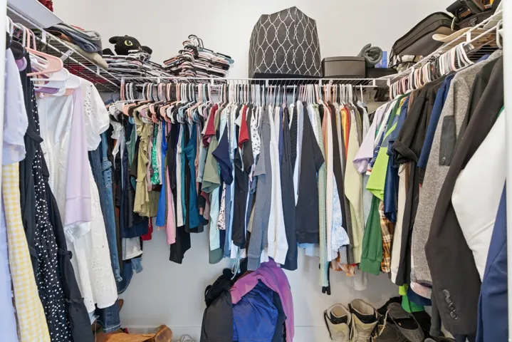 Walk-in closet featuring white wire shelving and hanging rods