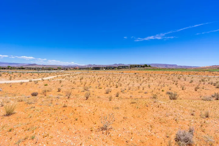 Expansive land parcel featuring desert landscaping and distant mountain ranges