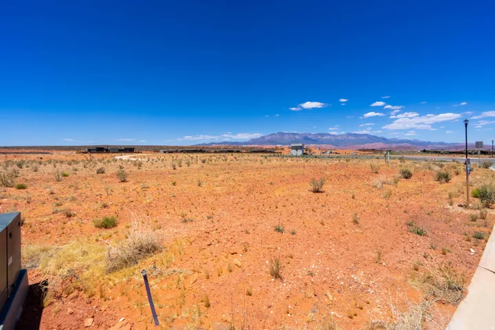 Expansive undeveloped lot featuring red earth terrain