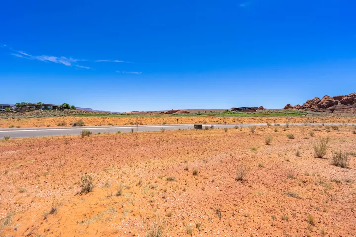 Expansive desert landscape with a paved road