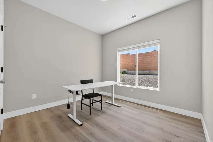 Room featuring light gray painted walls and wood-finish flooring
