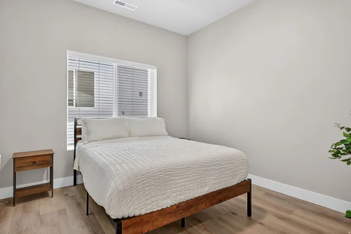 Bright room featuring light-toned walls and wood-finish flooring