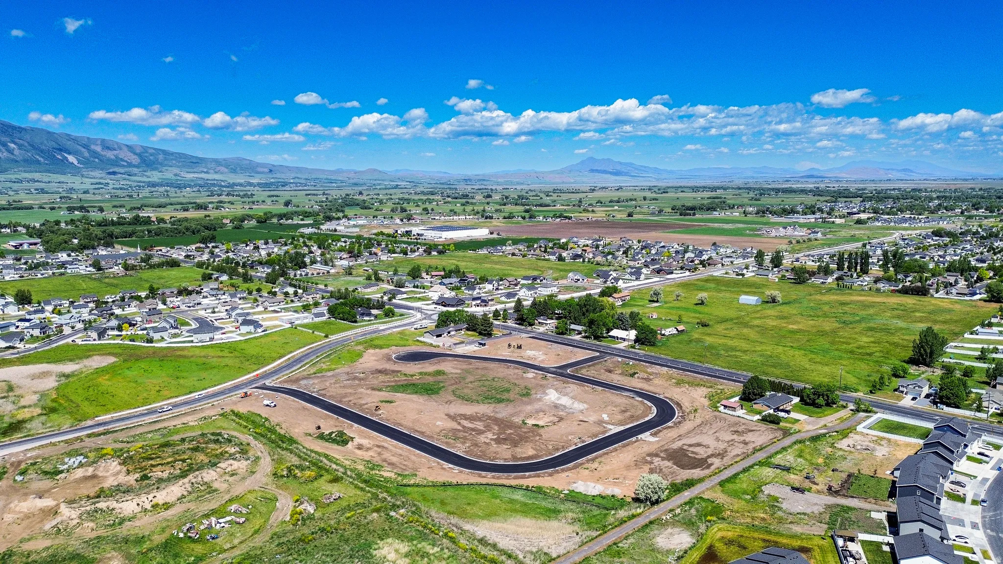 Developing residential area featuring newly paved roads and clear building lots