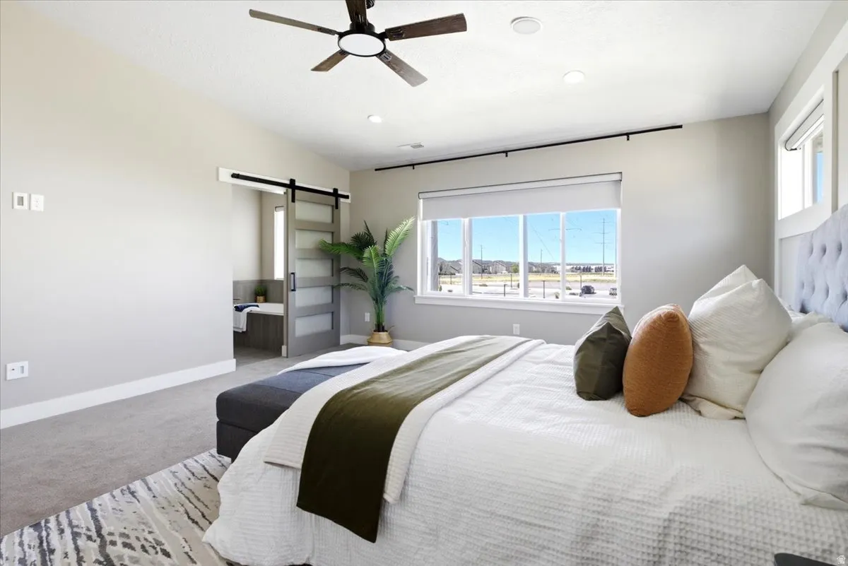 Carpeted room featuring a modern ceiling fan with integrated lighting, recessed lighting, and a large window with window treatments