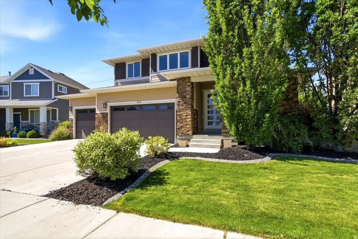 Contemporary two-story residence featuring a stone and stucco exterior
