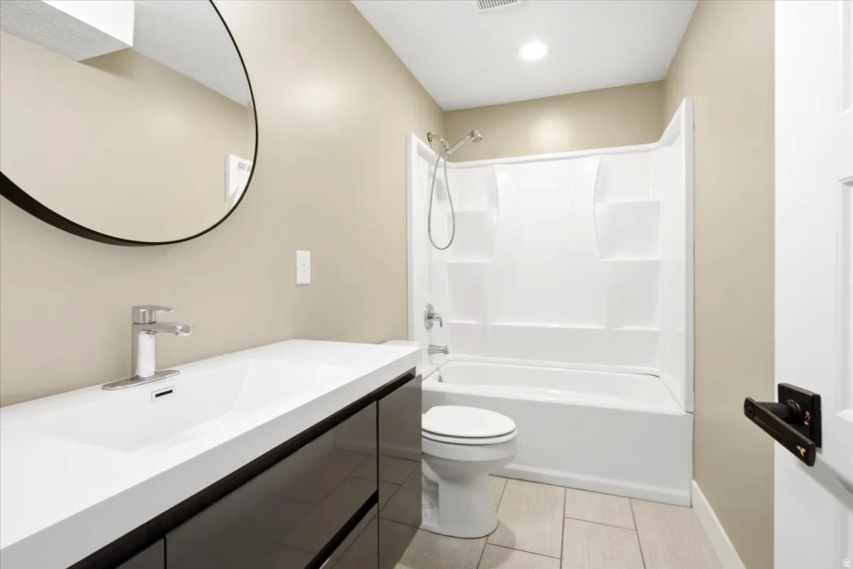 Modern bathroom featuring a single floating vanity with an integrated sink and chrome faucet