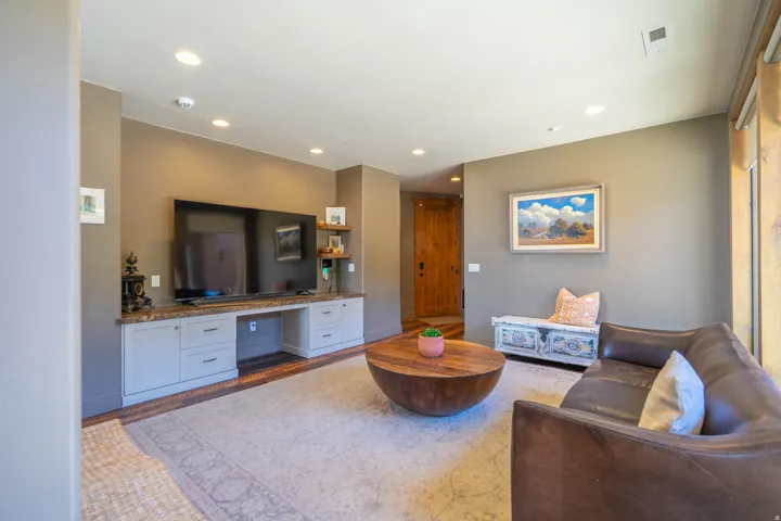 Living area featuring recessed lighting, light-toned walls, and wood-finish flooring