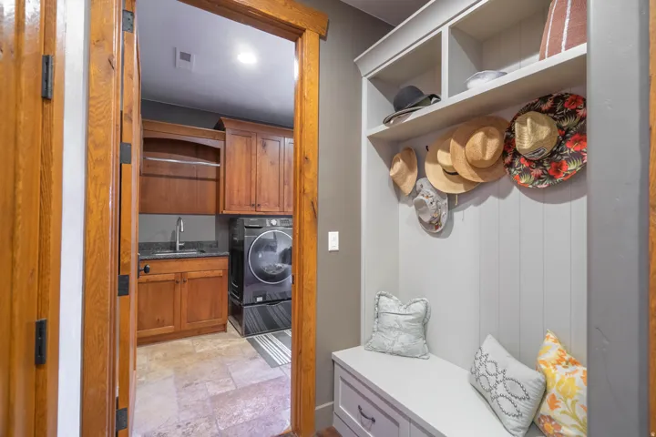 Mudroom with built-in storage bench and upper shelving