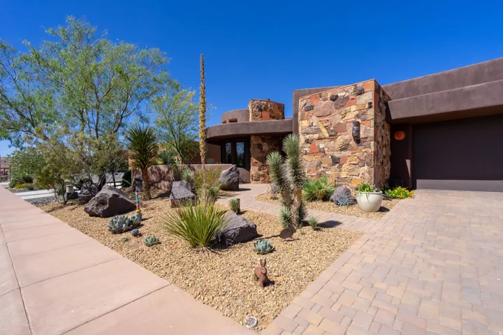 Desert-adapted landscaping featuring varied rock elements and diverse plantings