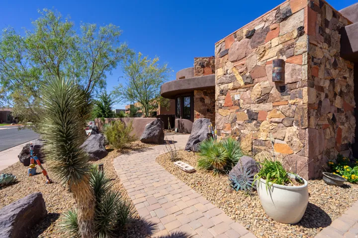 Exterior stone veneer wall with an attached sconce light
