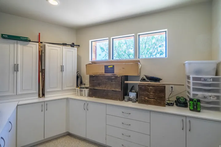 Built-in white cabinetry and countertops provide ample storage and workspace