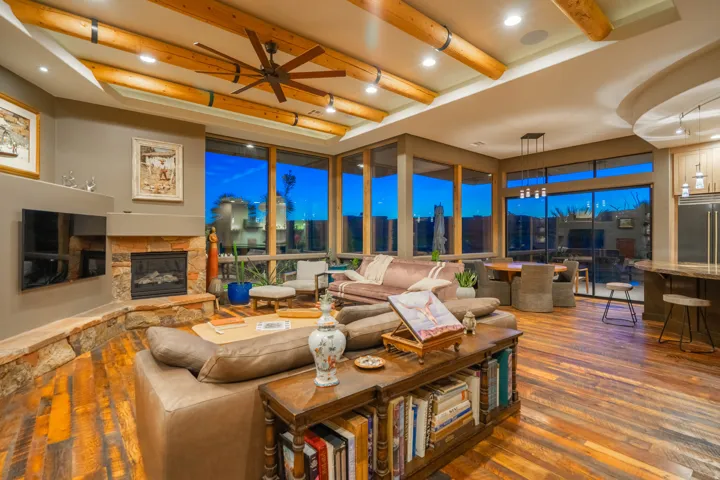 Living space featuring wood-finish flooring and exposed ceiling beams