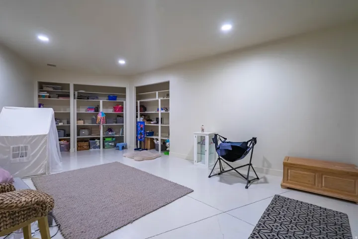 Spacious room featuring recessed lighting and built-in shelving
