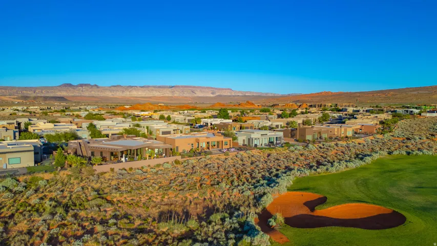 Aerial perspective showcasing a residential community with desert landscaping and an adjacent golf course
