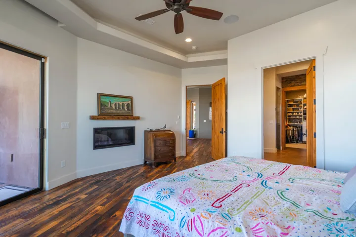 Spacious interior featuring wood-finish flooring, a contemporary built-in fireplace with a wood mantle, and a sliding glass door