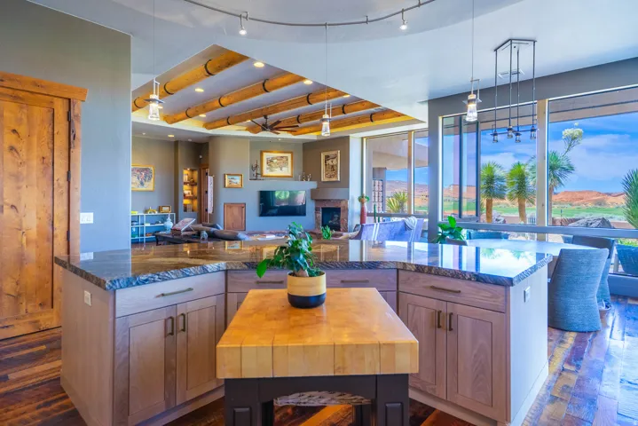 Kitchen island featuring a butcher block prep area and stone countertops